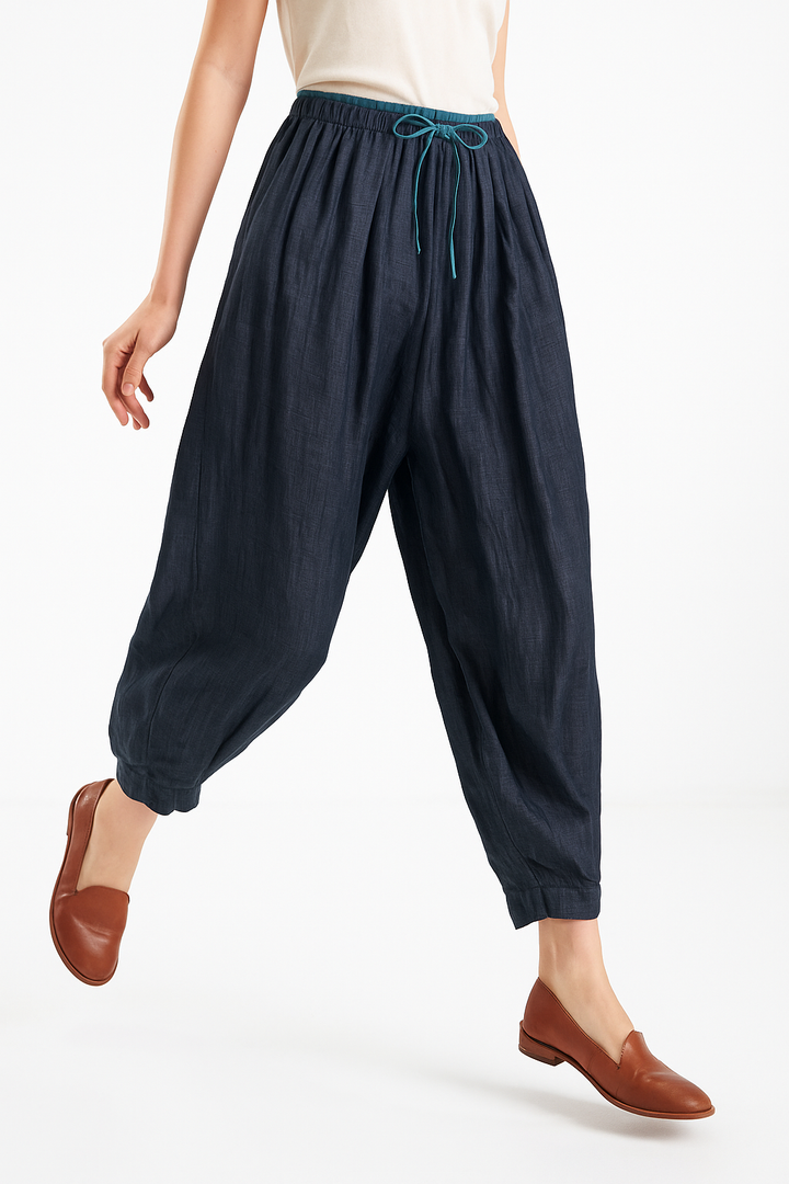 Breathable women's linen trousers, offering a relaxed tapered fit perfect for summer fashion.