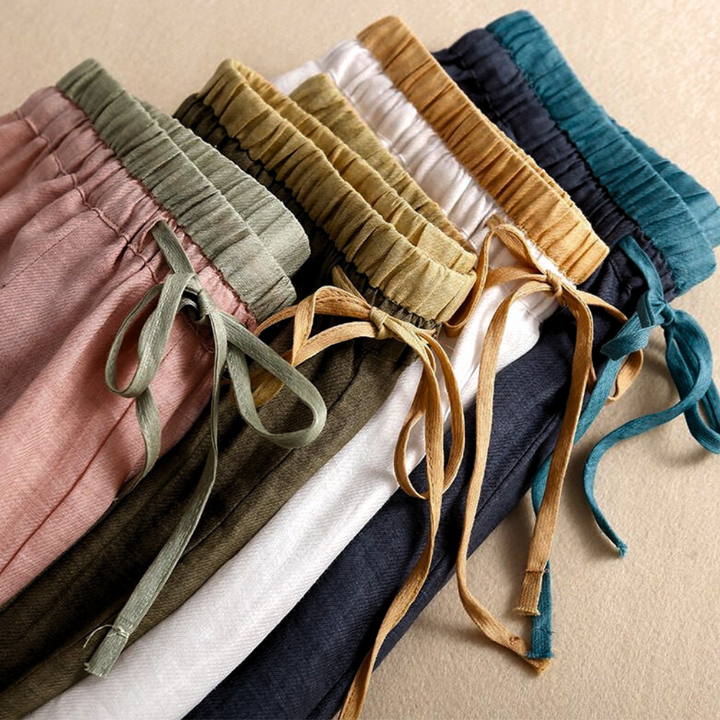 Full length image of women's relaxed tapered linen trousers, suitable for various casual occasions.