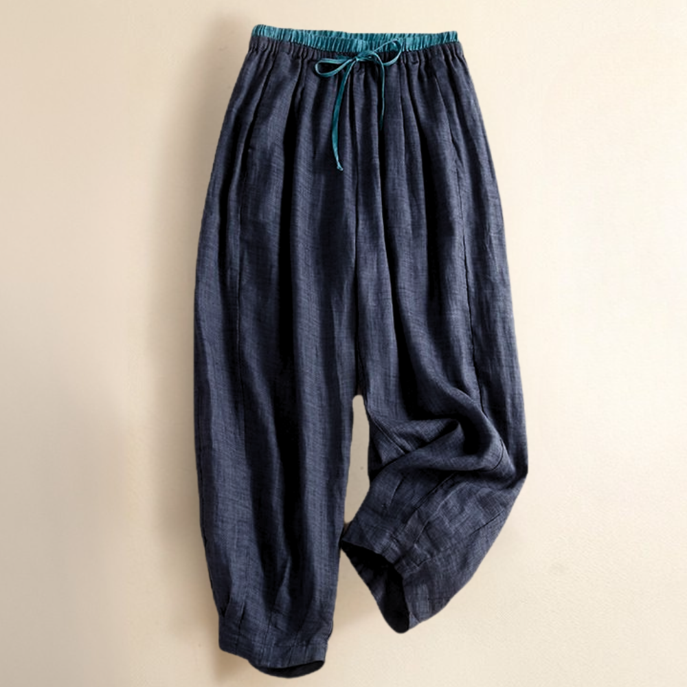 Close-up of the breathable linen fabric on women's tapered trousers, great for summer fashion.