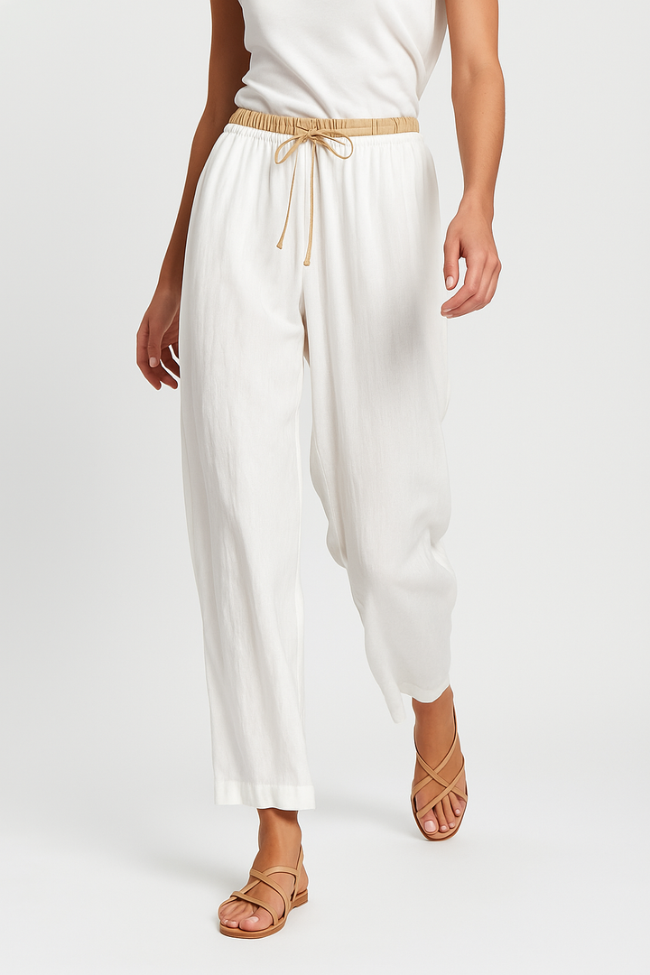 Detail of the tapered leg design on women's relaxed fit linen trousers, a modern summer staple.