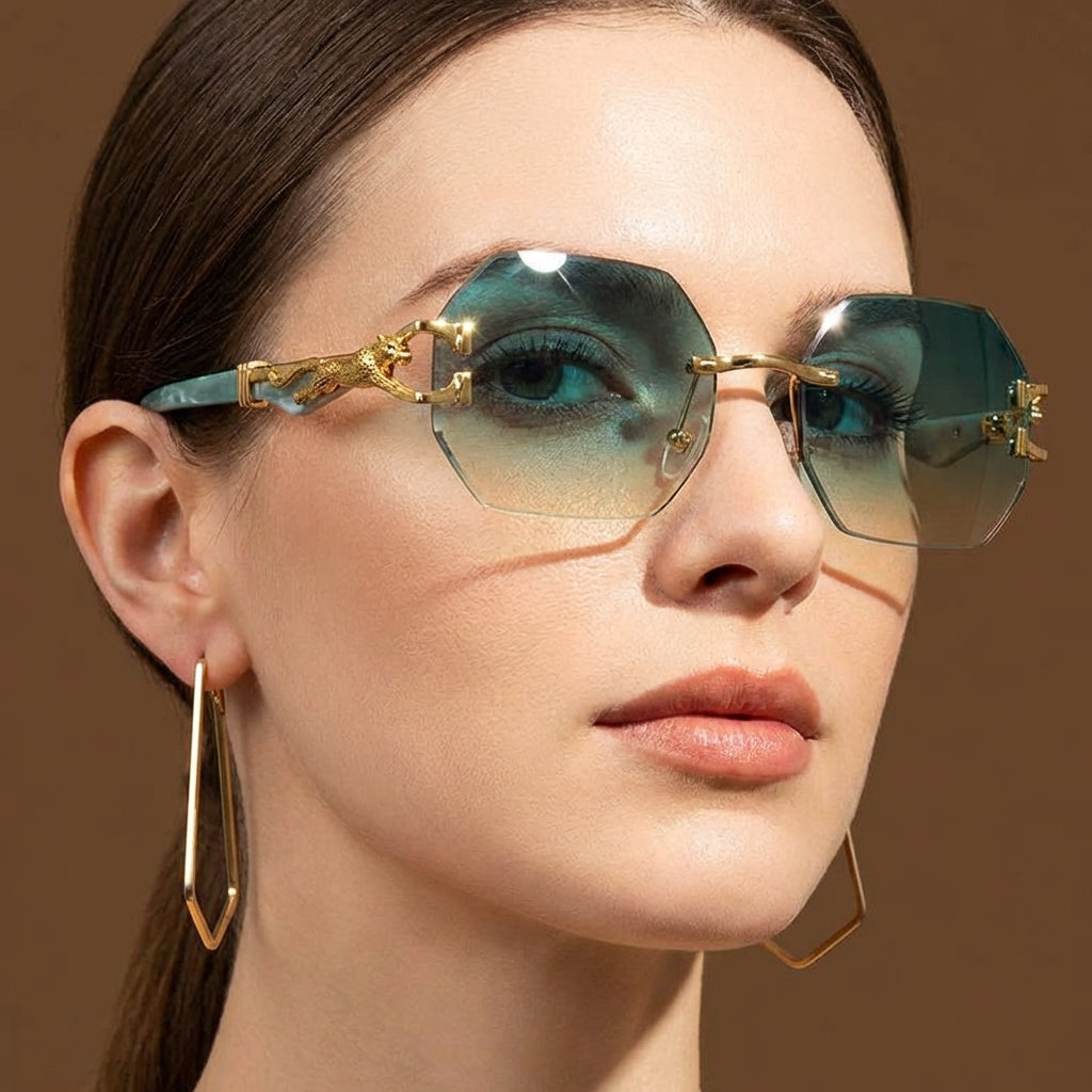 Women's rimless geometric sunglasses with striking gold panther detail. Luxury fashion eyewear for a chic look.
