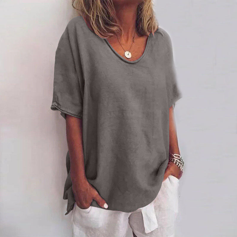 Fashionable women's scoop neck blouse. Loose fit short sleeve top for comfortable and stylish everyday wear.