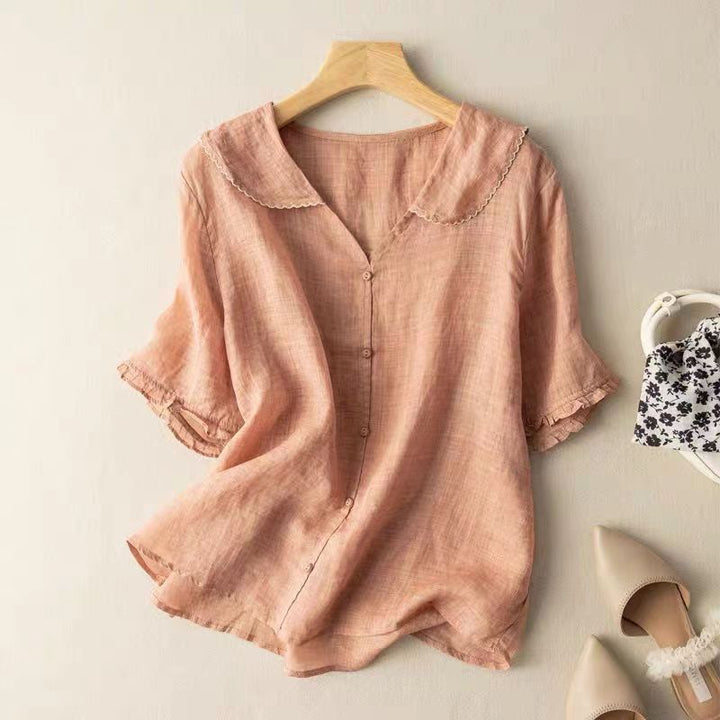 Feminine women's relaxed fit short sleeve blouse, featuring a stylish button front and scalloped neckline, ideal for summer.
