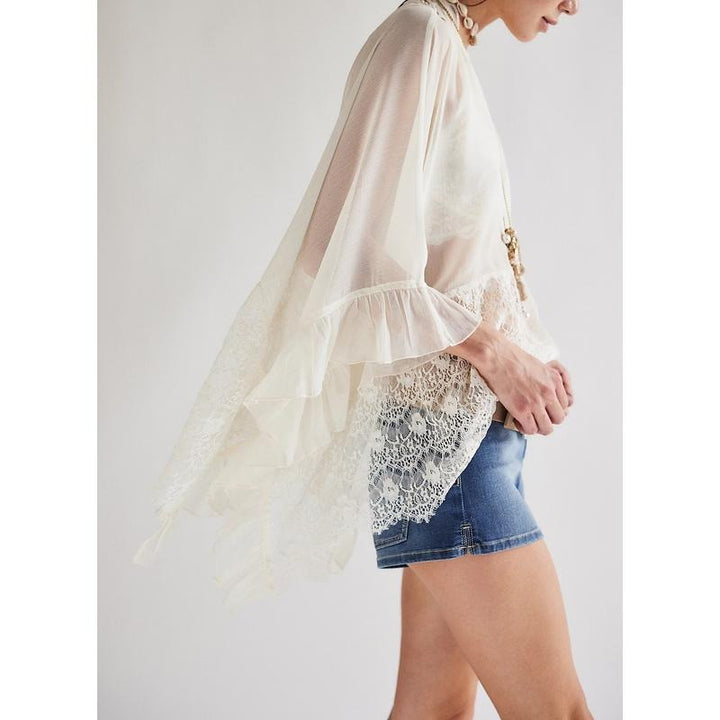 Boho-chic Women's Siena sheer lace poncho top, ideal for elegant summer apparel outfits.