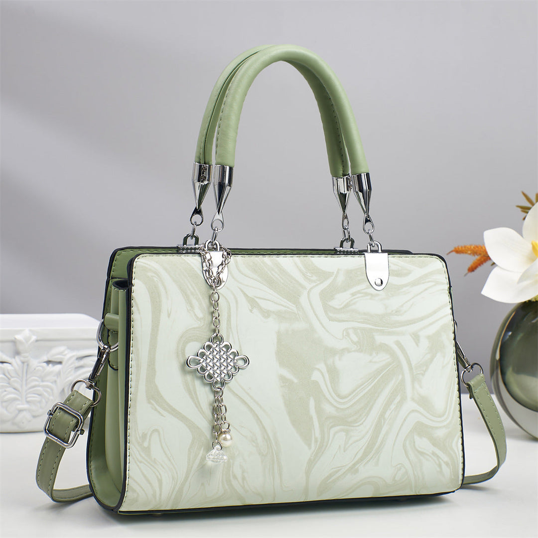 Chic black square crossbody bag for women, a minimalist accessory with a stylish chain strap