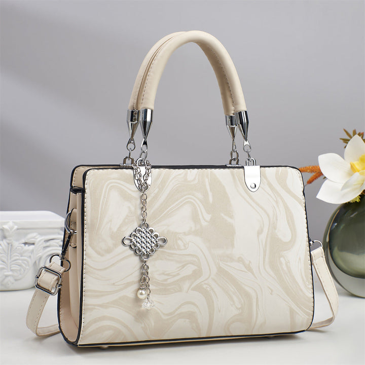 Modern women's square bag, featuring a crossbody chain strap, perfect for a refined look