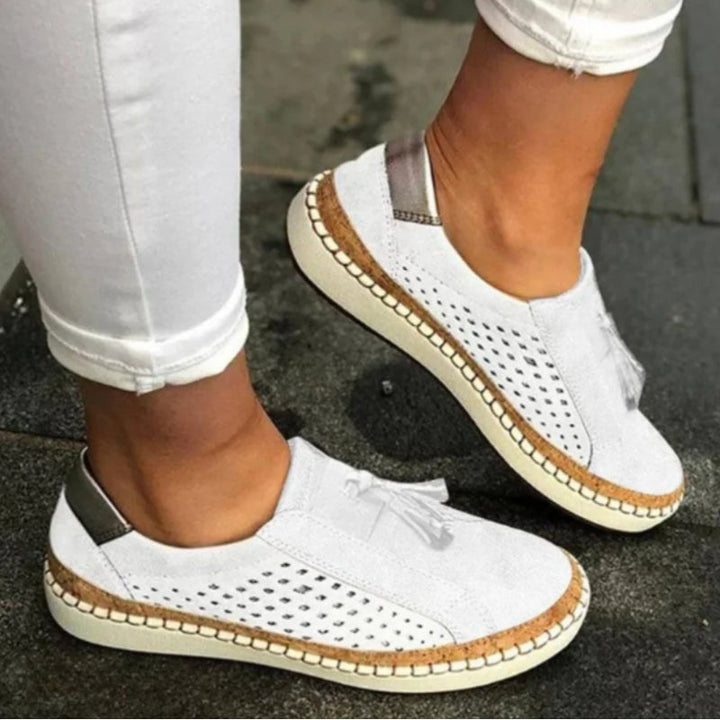 Stylish women's slip-on shoes with tassel detail, offering orthopedic arch support & breathable comfort for casual walks.