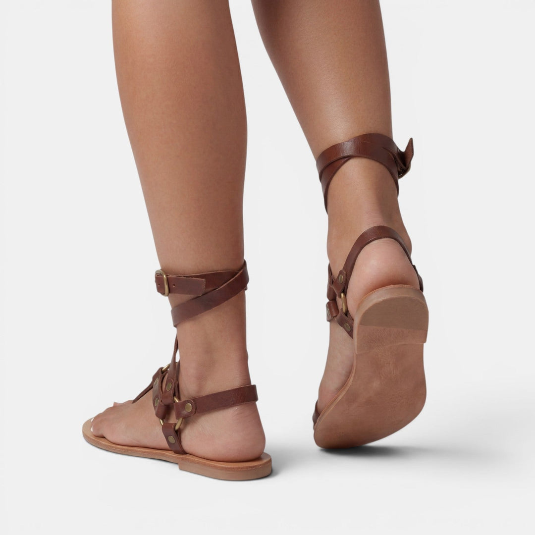 Trendy women's snake print flat sandals with buckle straps, ideal for everyday summer wear.