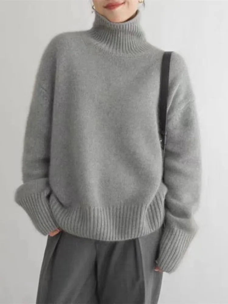 Detail of the funnel neck collar on a luxurious and soft cashmere sweater for women