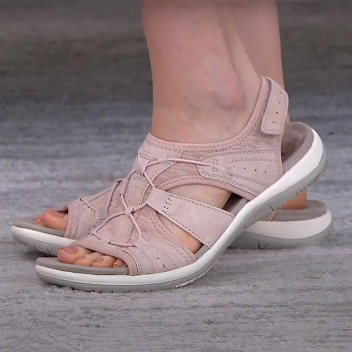 Model wearing women's grey sporty comfort sandals while walking outdoors in spring