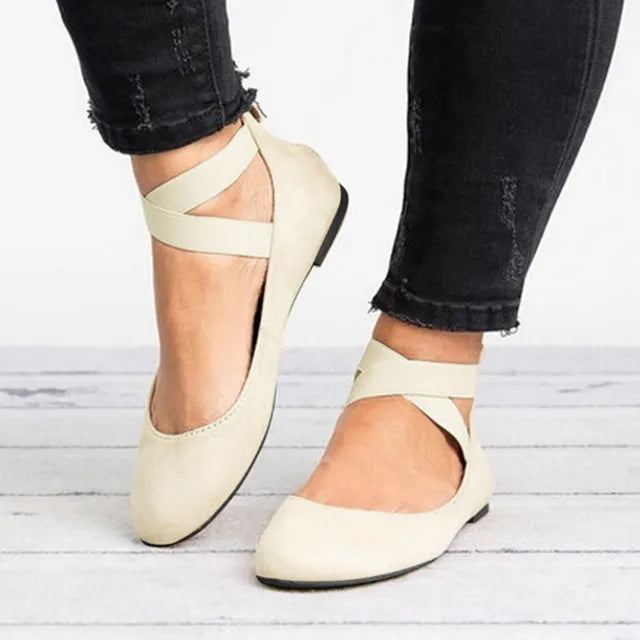 Women's spring cross-strap ballet flats in a close-up, showing intricate strap detail and soft material