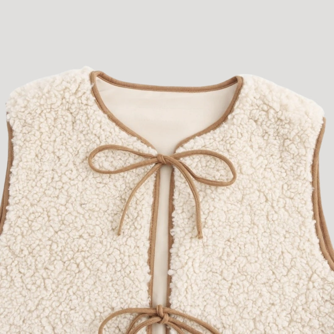 Cozy beige vest for women, featuring a stylish tie-front, great for casual spring outfits.