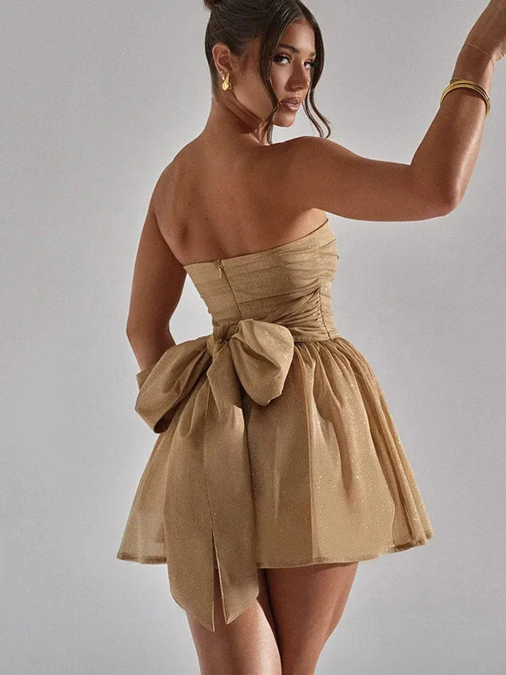 Elegant strapless mini dress for women, featuring a pleated bodice and a stylish flared hem.