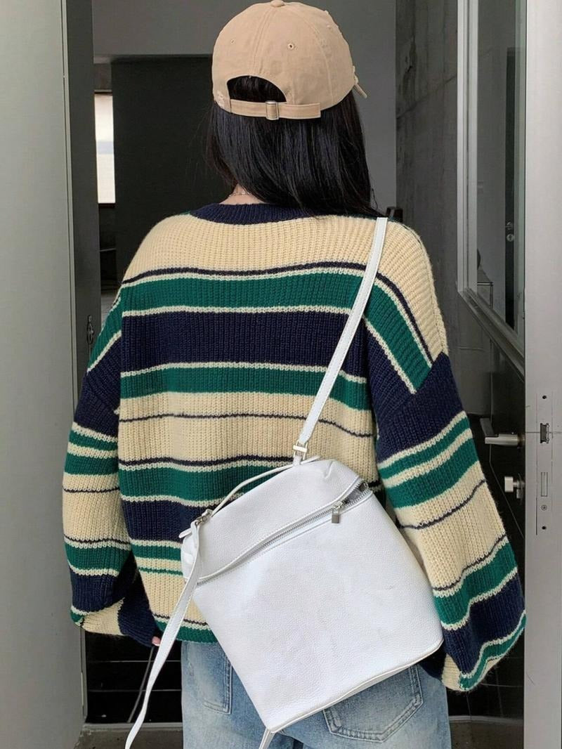 Model wearing a comfortable women's striped knit wool blend relaxed sweater, great for everyday casual wear