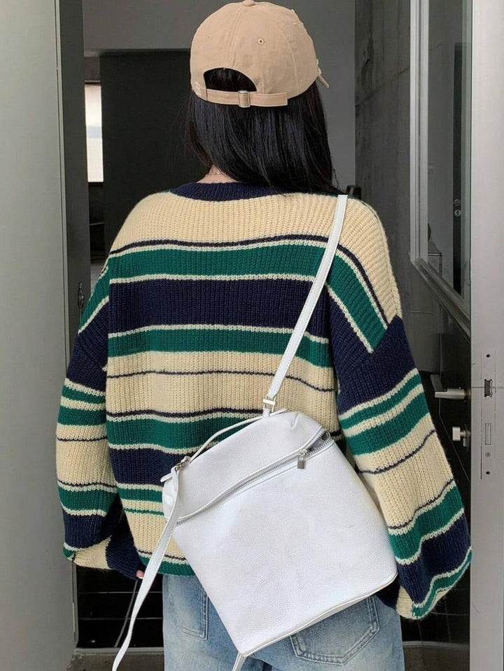 Model wearing a comfortable women's striped knit wool blend relaxed sweater, great for everyday casual wear