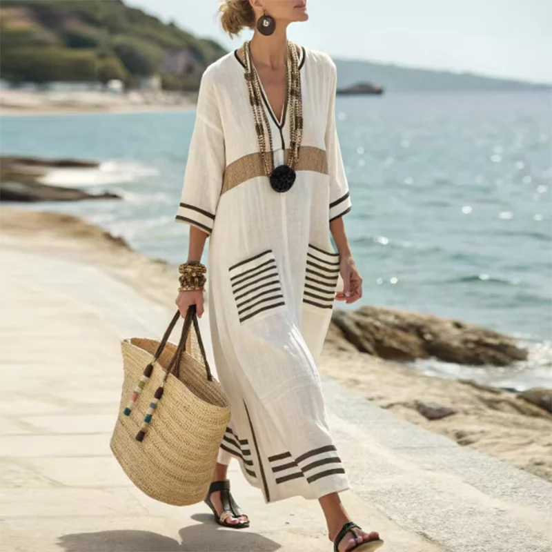 Versatile women's striped kaftan dress, a maxi resort wear essential for casual summer & beach days.