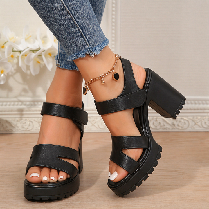 Chic women's flat open-toe sandals, perfect for casual summer outings. Comfortable & stylish footwear for daily wear.