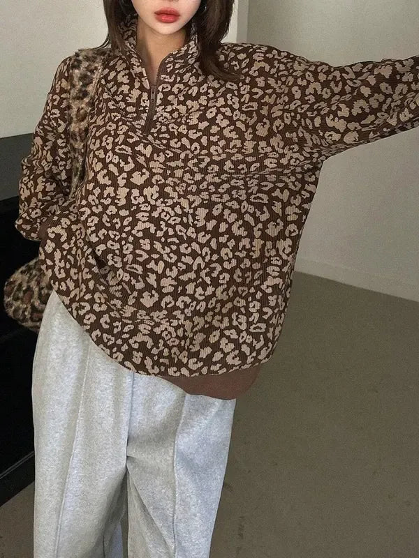 Trendy women's sweater featuring a bold leopard print and practical half-zip closure