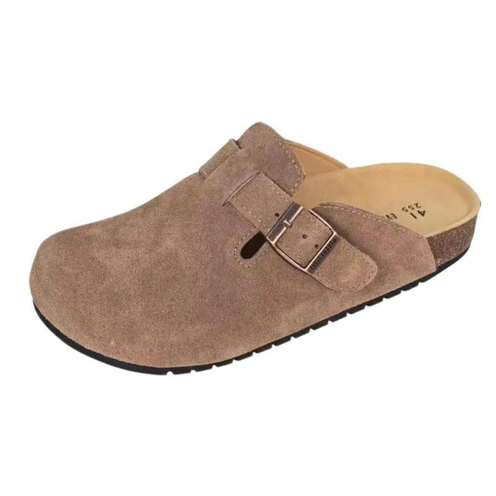 Close-up of women's slip-on suede clogs, featuring a supportive cork footbed