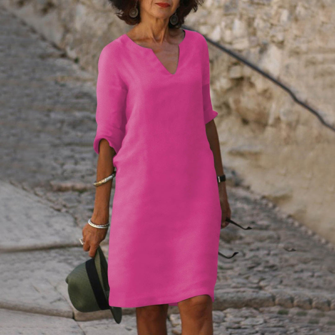 Flowy women's V-neck midi dress, offering comfortable, casual style for warm summer days.