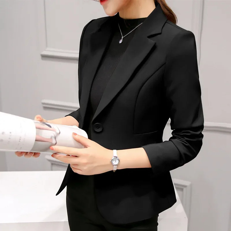 Elegant women's tailored blazer in navy blue, close-up of lapel and single button closure