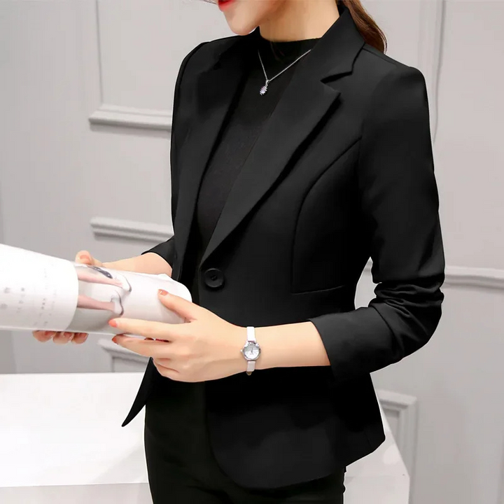 Elegant women's tailored blazer in navy blue, close-up of lapel and single button closure