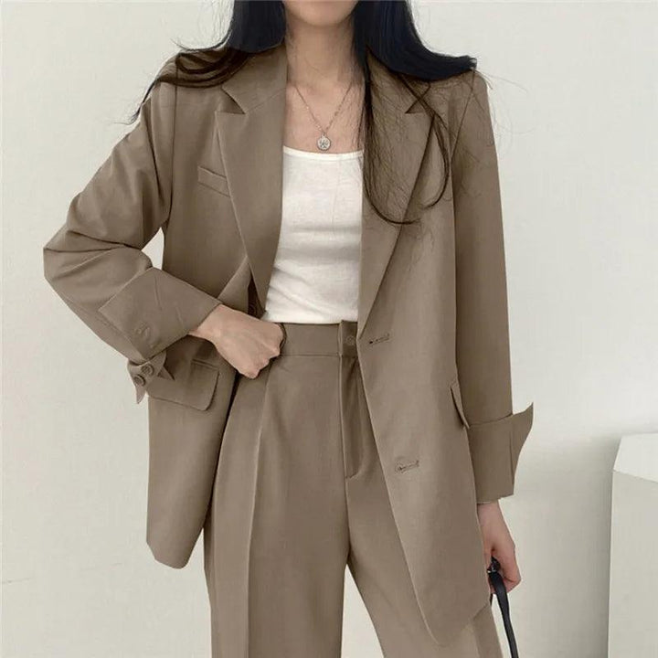 Versatile women's suit set, including a long blazer and tailored trousers, for multiple professional settings.