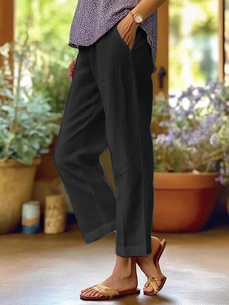 Stylish women's pants with tapered leg, cropped length, and cuffed hem for modern fashion.