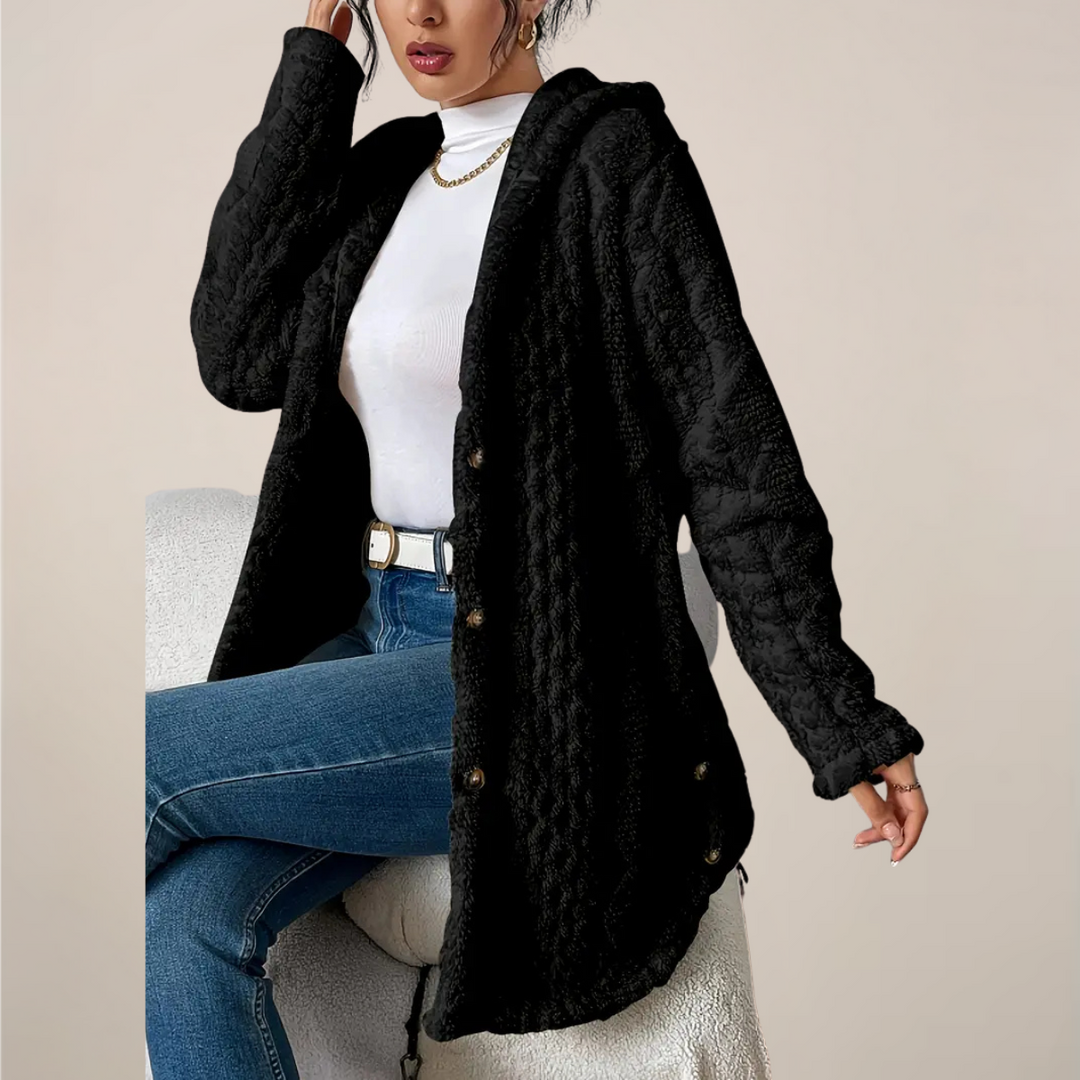 Close-up of the textured knit fabric on a women's long hooded cardigan, showing detail