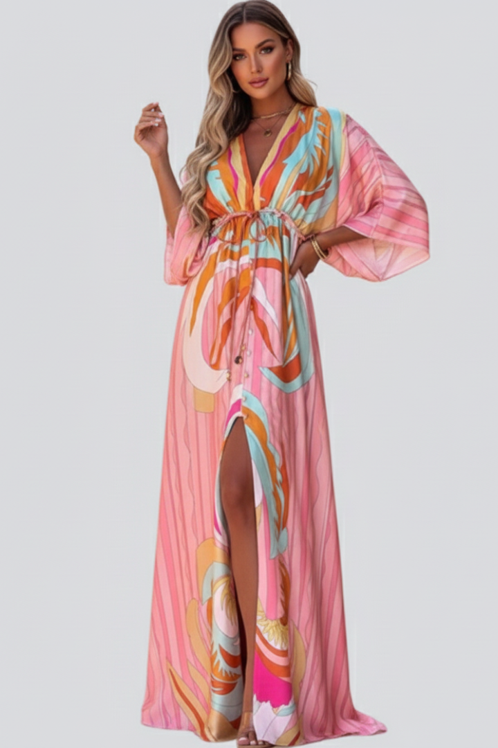 Flowing pink abstract print maxi dress for women, featuring a flattering V-neck and a chic belt for spring/summer.