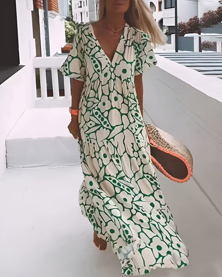Women's V-neck abstract print maxi summer dress, flowy and elegant for casual wear.