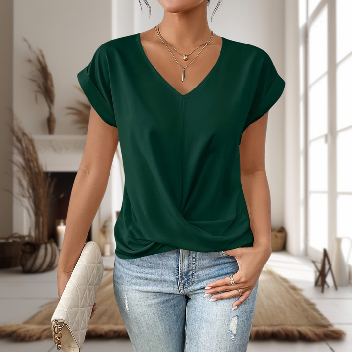 Soft women's V-neck blouse featuring a trendy twisted hem. Elegant short sleeve top for daily wear.