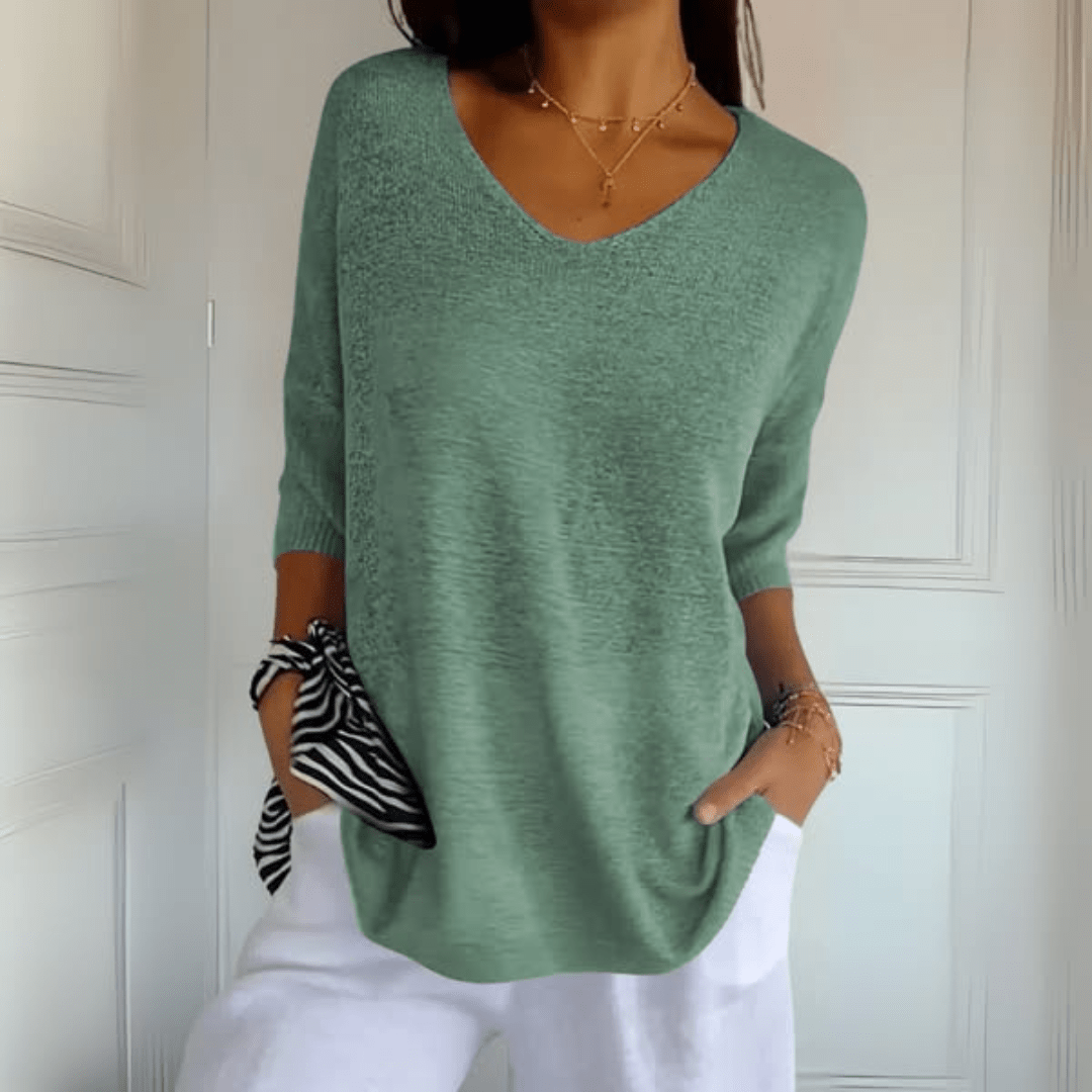 Comfortable women's V-neck knit sweater. Loose fit & hip length for versatile style.