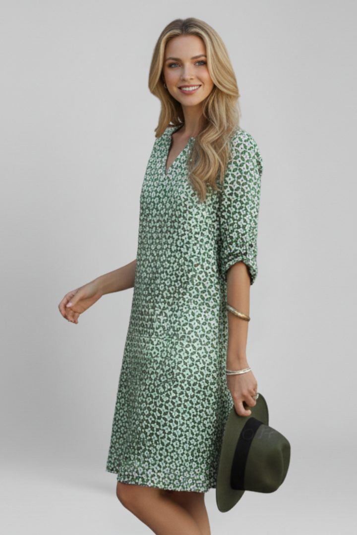 Women's short sleeve V-neck dress with spotted print. Knee-length, comfortable fit & flare style.