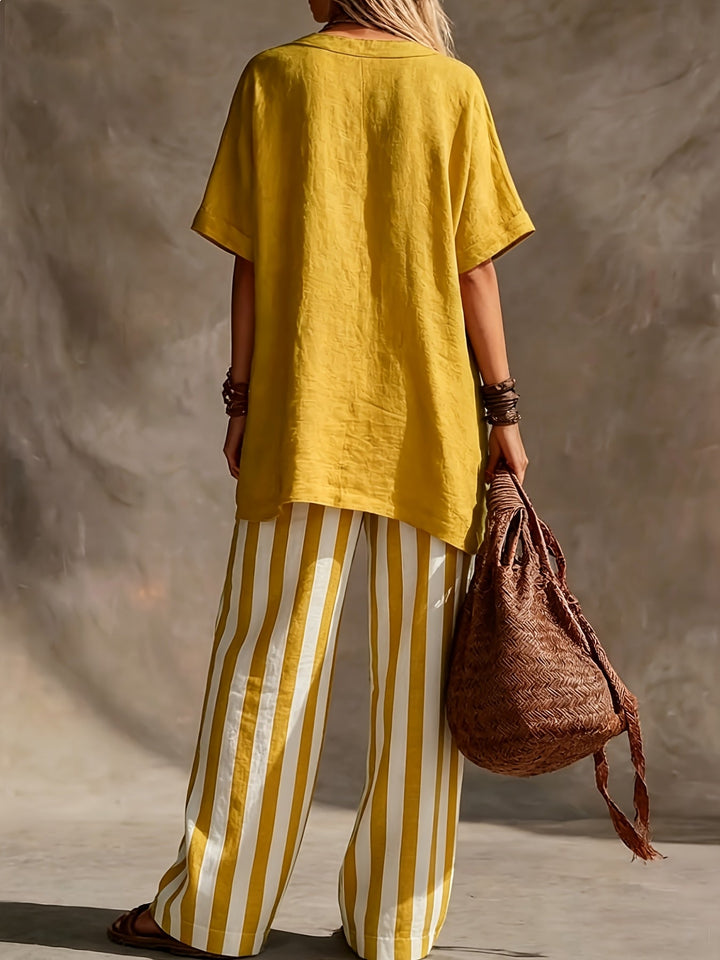 Elegant women's two-piece set featuring a V-neck top & stylish striped wide leg pants, ideal for resorts.