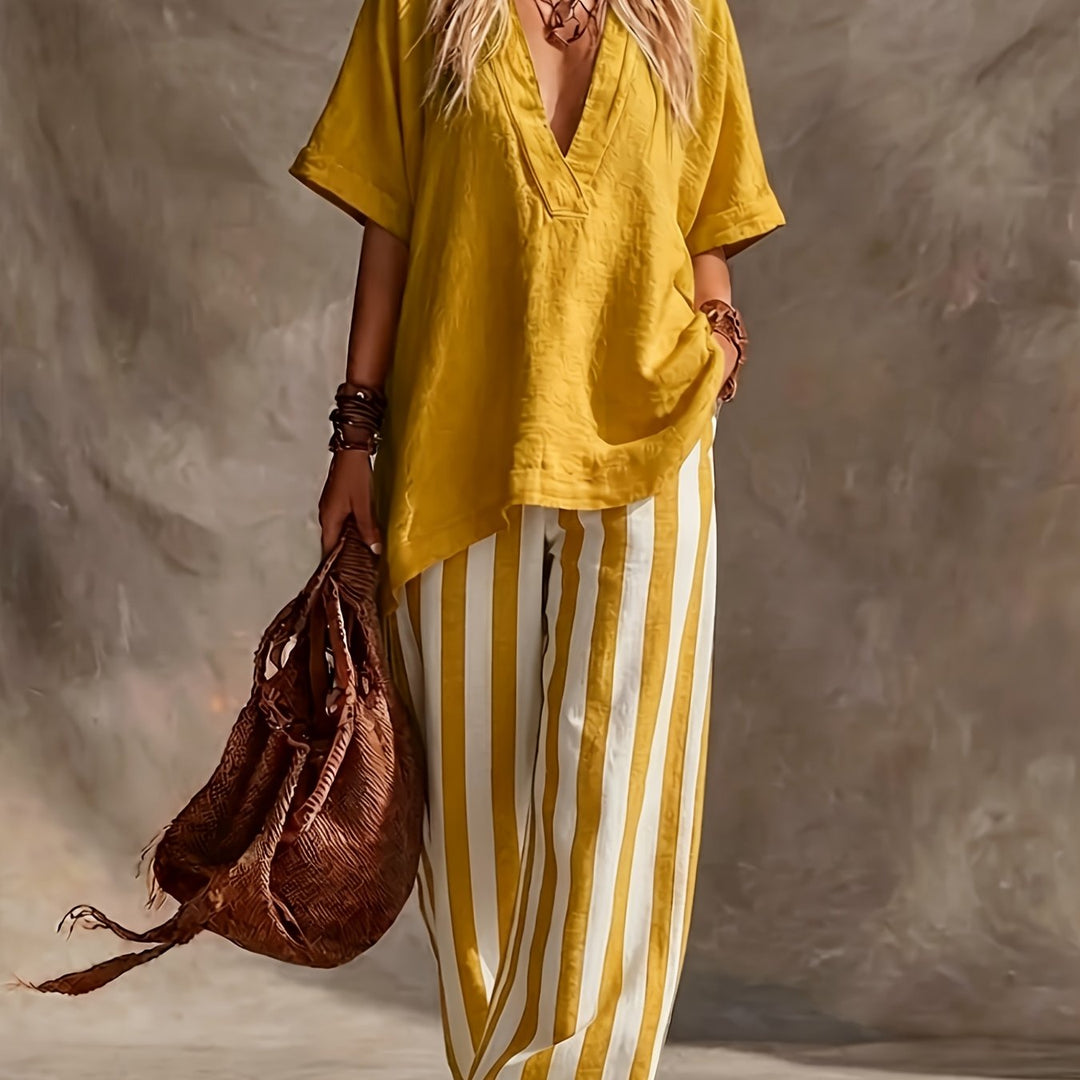 Casual elegant V-neck top & striped wide leg pants, essential women's summer outfit for effortless style.