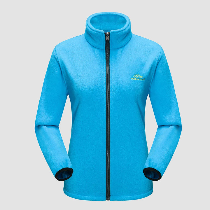 Woman checking her phone, hands in pockets of her Verona 3-in-1 waterproof jacket, functional outerwear.