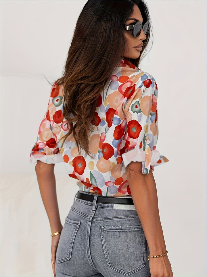 Artistic abstract floral print women's button down blouse, long sleeve. Vibrant, relaxed fit for spring fashion.