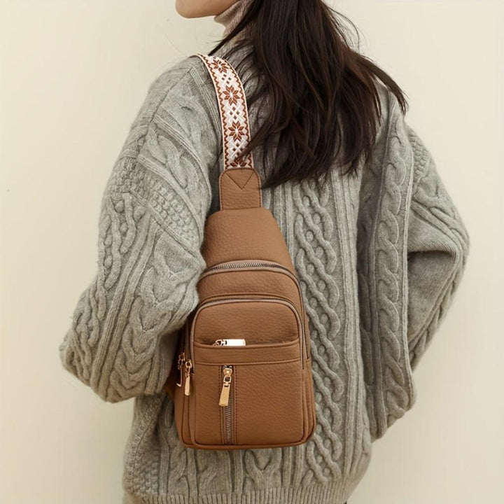 Elegant vintage women's crossbody bag in premium brown leather, close-up of texture.