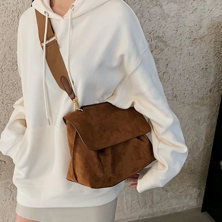 Women's vintage brown suede crossbody bag with flap closure, adjustable strap, a luxurious fashion accessory