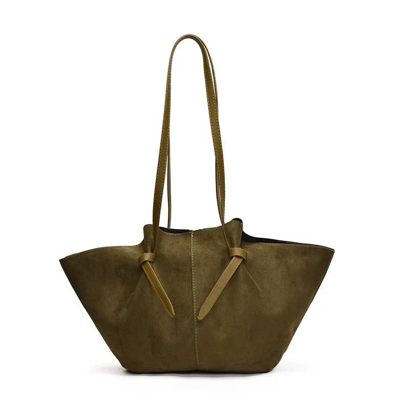 Women's faux suede tote handbag with a long shoulder strap and top handles, versatile carry options