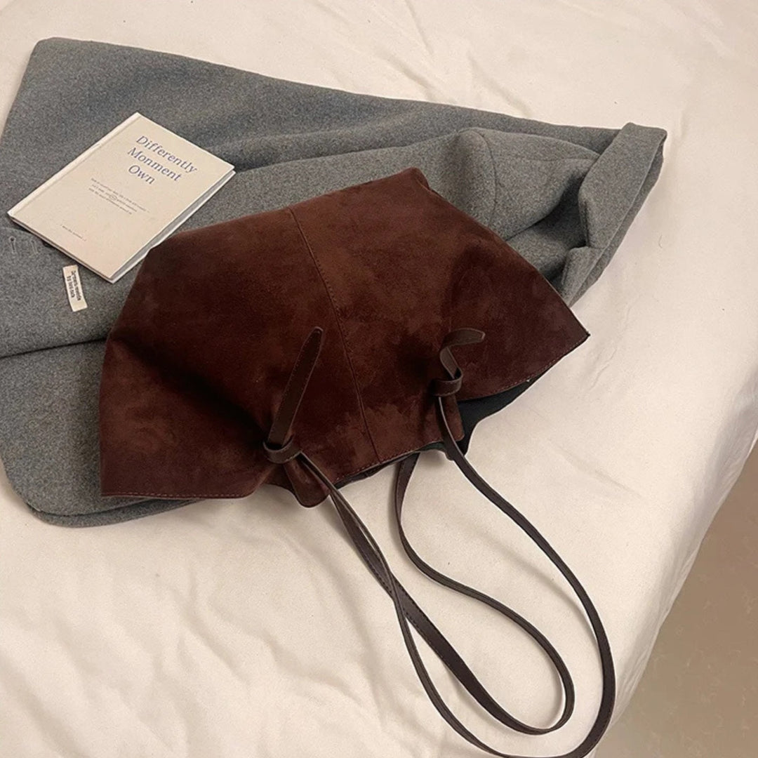 Open view of women's vintage faux suede tote handbag, revealing inner lining and spacious compartment