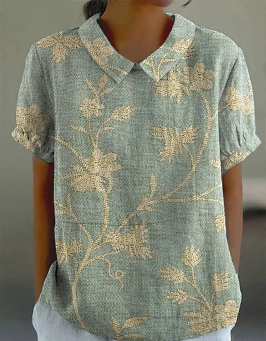 Women's vintage floral embroidered short sleeve blouse; a chic summer top.