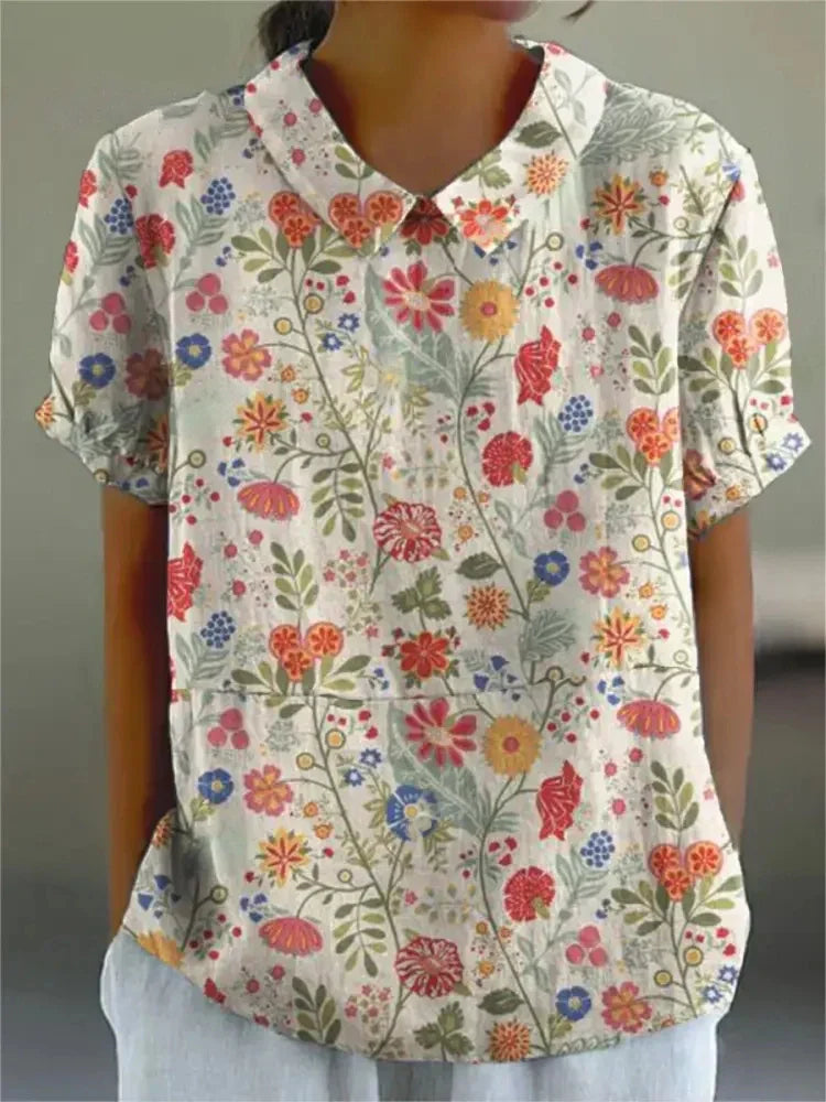 Elegant women's short sleeve top, vintage floral embroidery, ideal for a chic summer look.