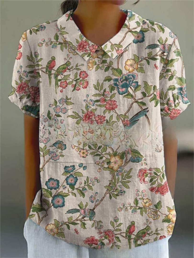 White women's summer blouse with vintage floral embroidery, short sleeve, stylish casual wear.