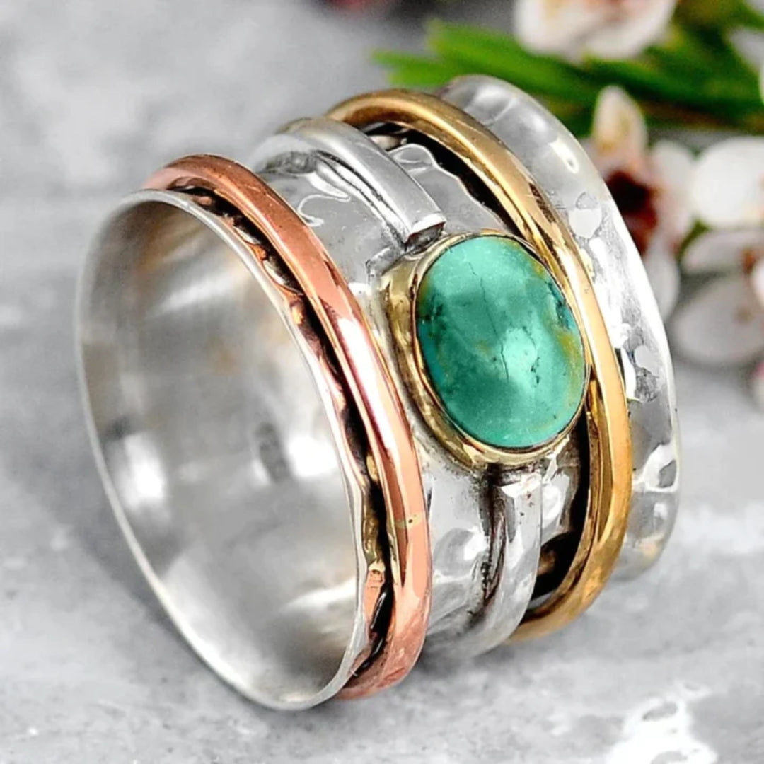 Women's vintage gold & silver ring featuring a striking turquoise gemstone. Elegant chic jewelry accessory.