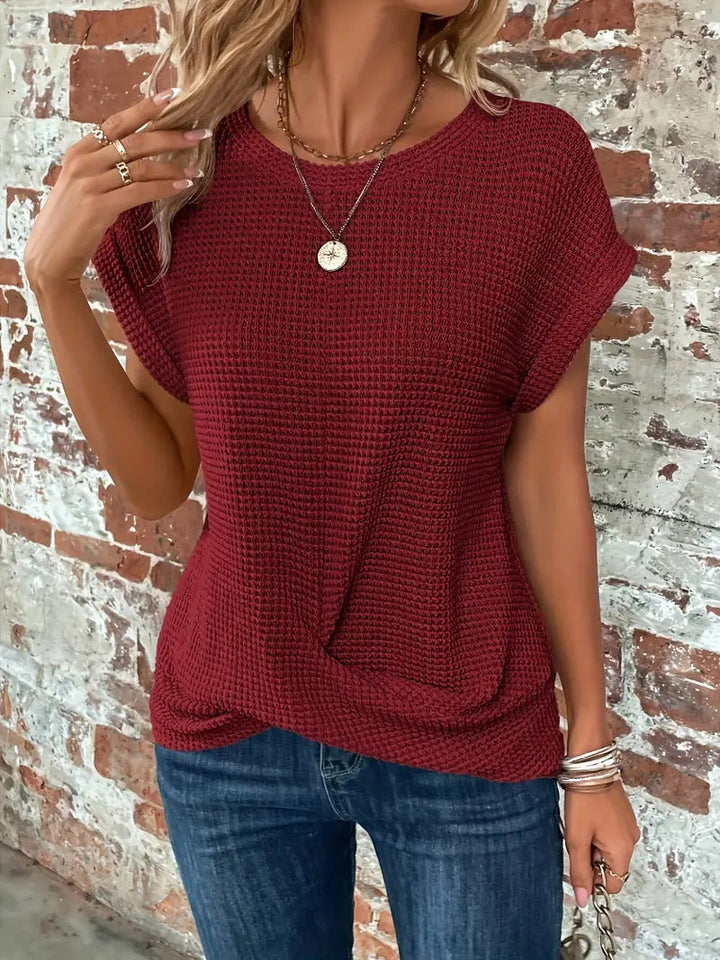 Casual women's waffle tee featuring a unique twist front. Short sleeve top for relaxed, everyday fashion.