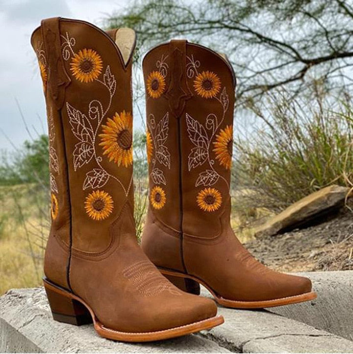Detailed close-up of women's sunflower embroidered cowboy boots, highlighting the unique western design and craftsmanship.