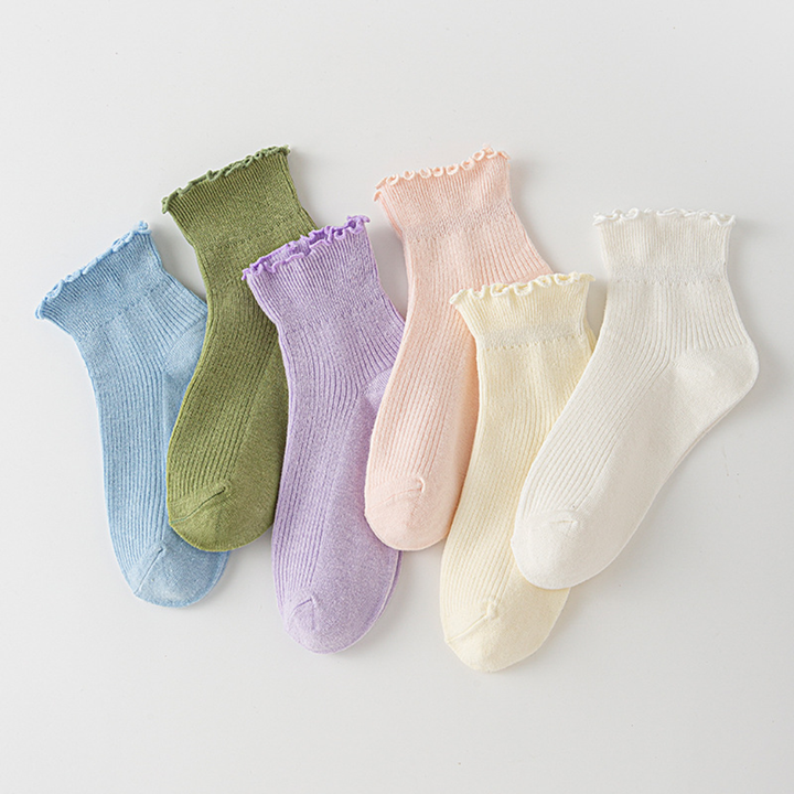 Women's white ruffle ankle socks with delicate lace trim, perfect for a cute & feminine everyday look.