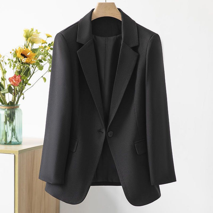 Close-up of a women's polyester tailored blazer, highlighting the fabric texture and sophisticated cut.